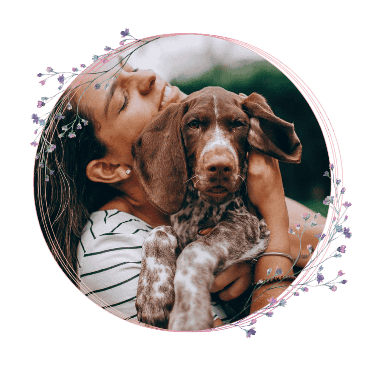 A person is hugging their dog in the grass